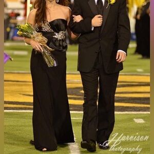Black evening gown with gold and diamond accents and bow